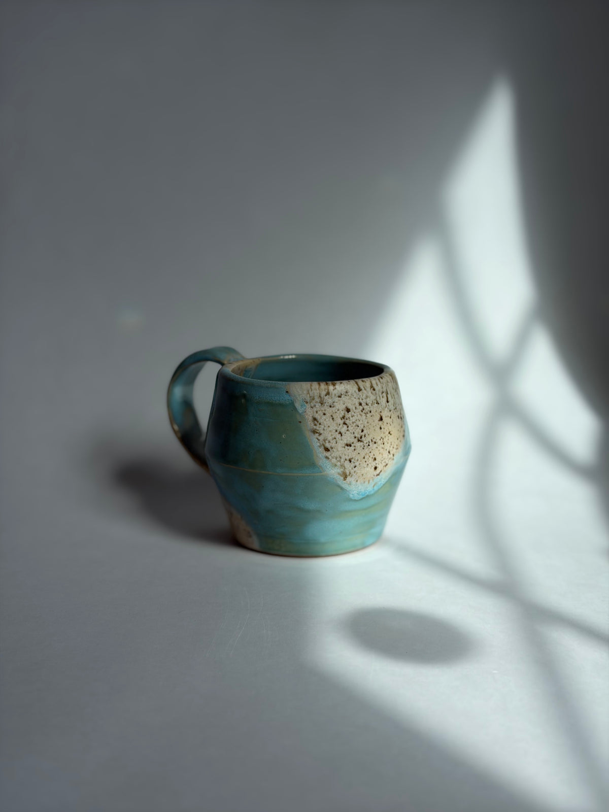 a blue and brown speckle teacup