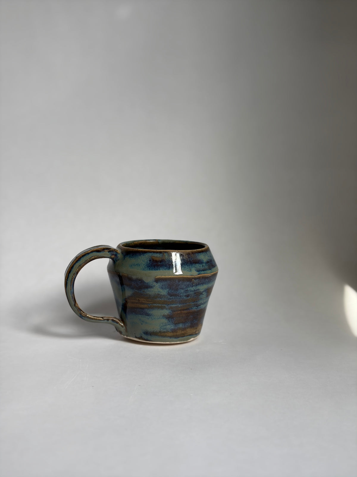 a brown and blue swirled teacup