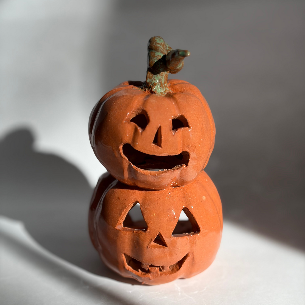 A stacked pair of joined jack-o-lantern figurines
