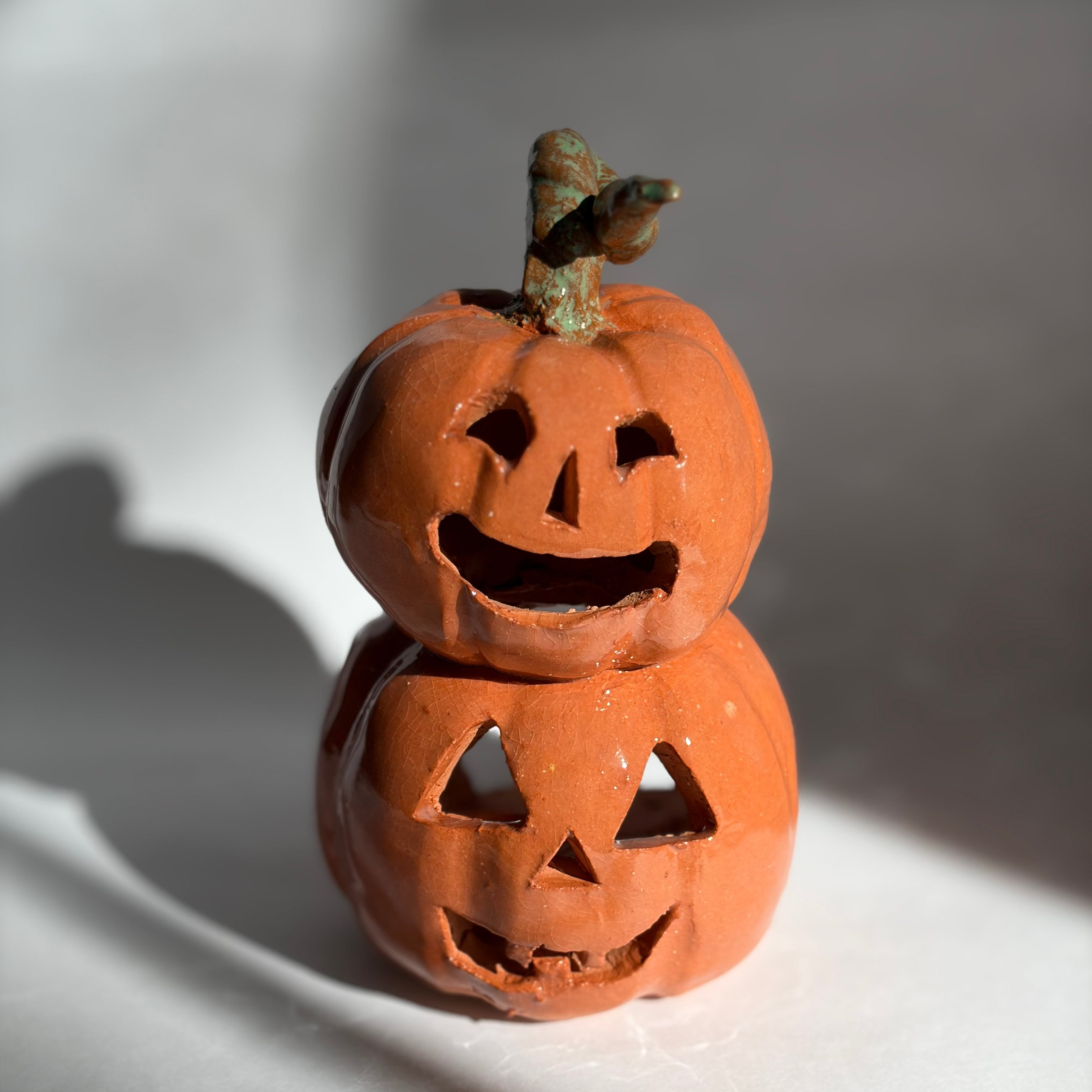 A stacked pair of joined jack-o-lantern figurines