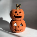 A stacked pair of joined jack-o-lantern figurines