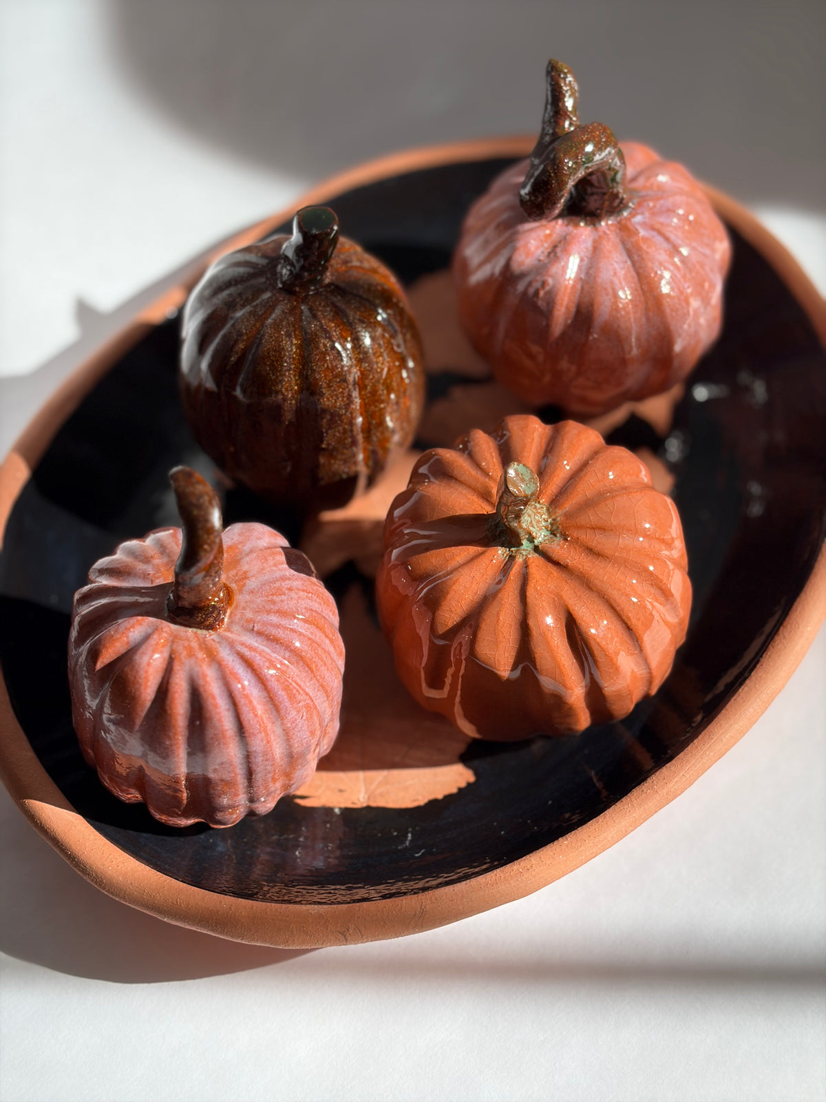 a terracotta tray of 4 terracotta pumpkins